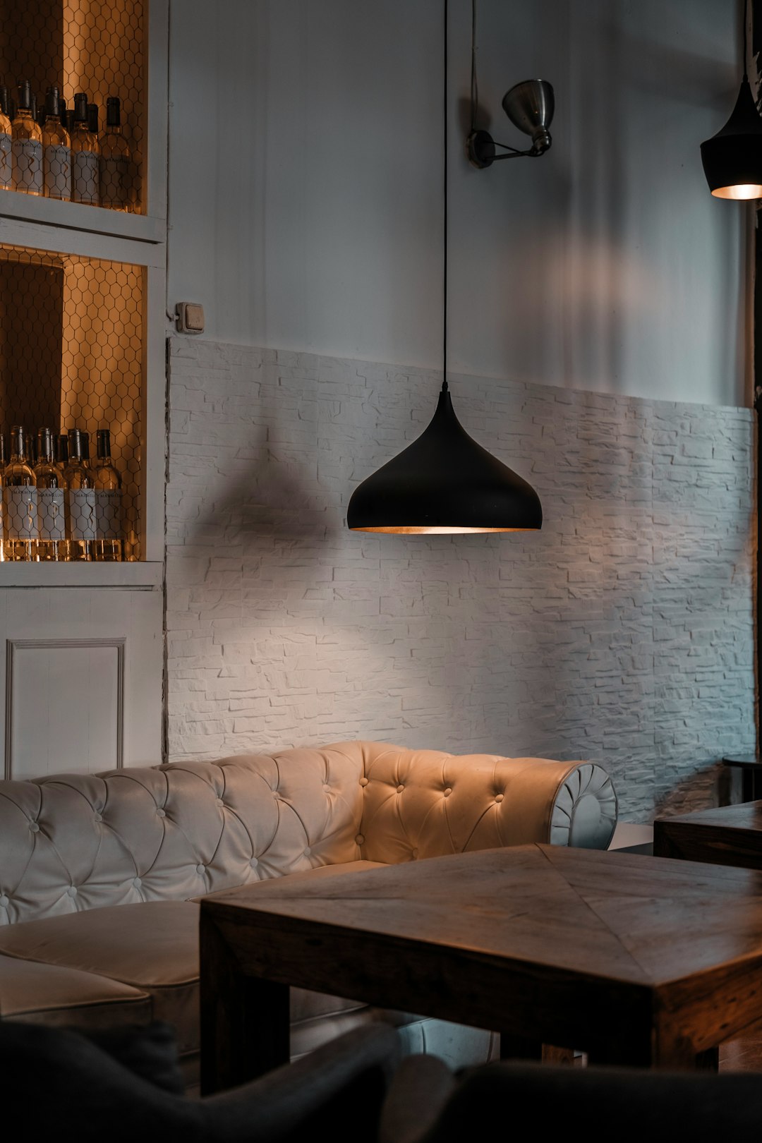 who-we-are tufted-sofa-near-coffee-table-mnz7igrcel0
